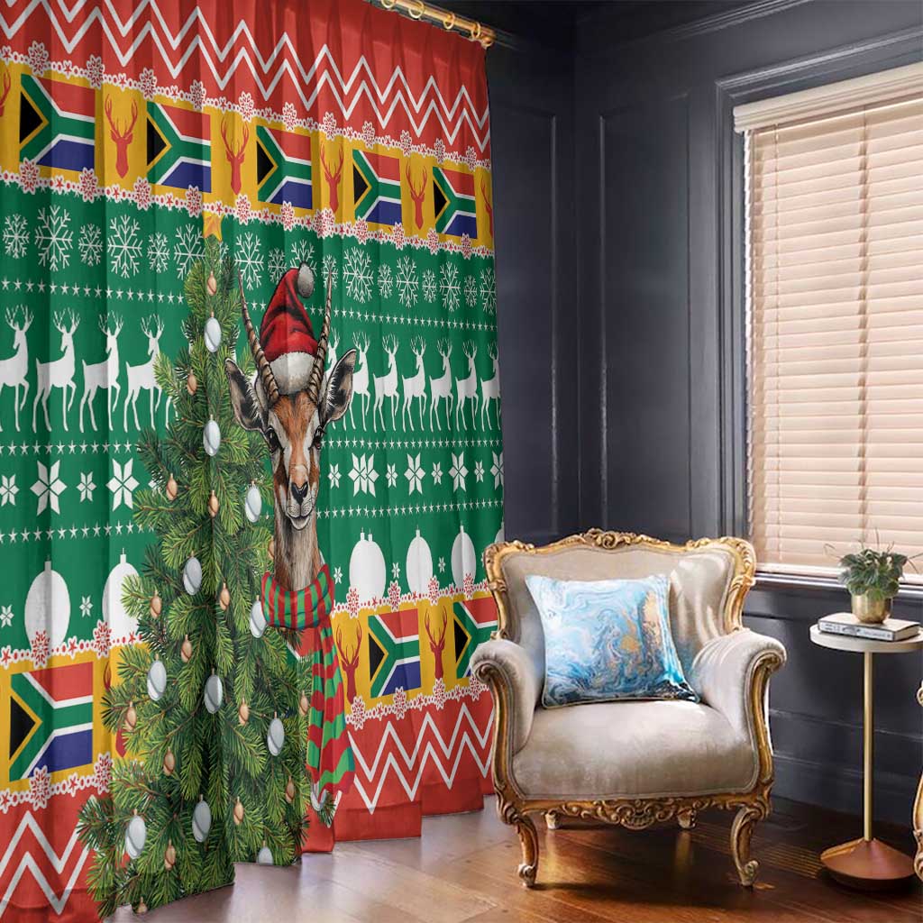 Green holiday curtain panel with springbok, antlers, candles and zigzag red trim