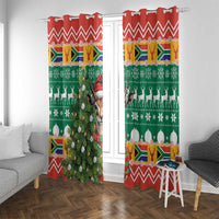 Two Christmas window curtain panels in green and red with springbok, candles and chevron trim