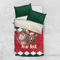 Christmas bedding set with green pillows and red comforter, deer in Santa hat, “Your Text”