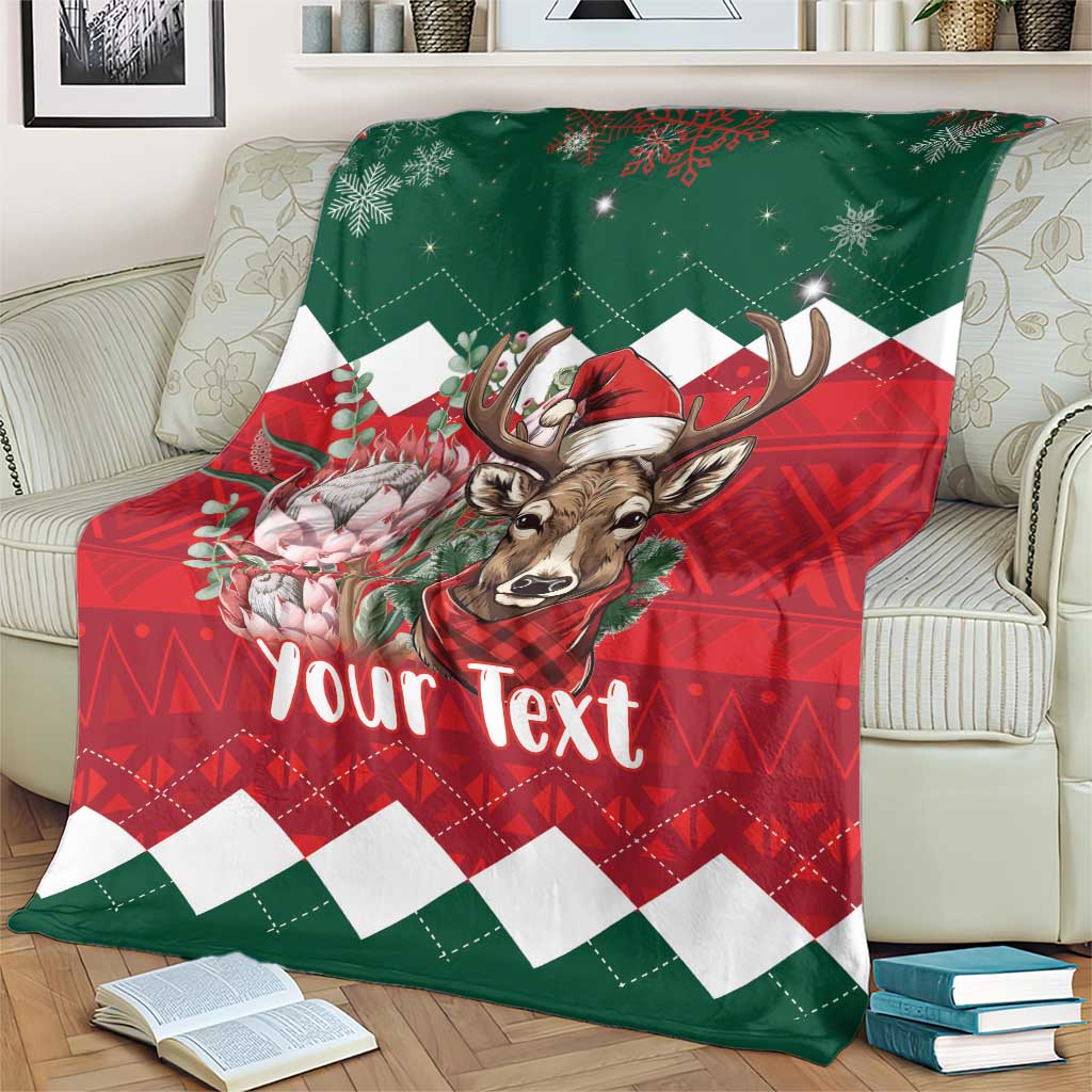 Personalized Christmas blanket on couch, green/red deer and floral accents, 'Your Text'