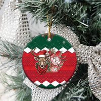 Ceramic round Christmas ornament hanging on silver tinsel, green top and red plaid reindeer floral