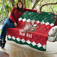 Personalized Christmas quilt laid out outdoors, red-green with reindeer and 'Your Text'