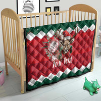 Personalized Christmas quilt in baby crib, red-green reindeer graphic and 'Your Text'