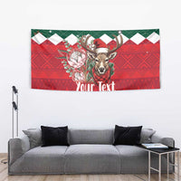 Green and red springbok Christmas tapestry with floral design and “Your Text”.