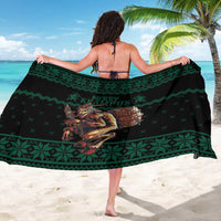 Green Christmas sarong with Krampus artwork and geometric border pattern, draped wrap
