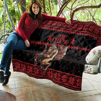 Black and red quilt draped on sofa, Krampus character and geometric band borders