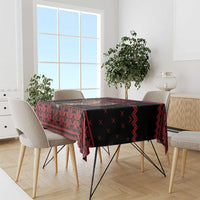 Red and black Krampus holiday tablecloth with geometric pattern on dining table
