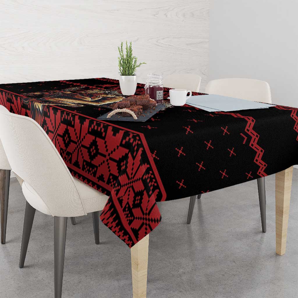 Red and black patterned holiday tablecloth draped over dining table
