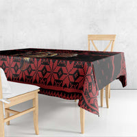 Red and black geometric holiday tablecloth covering table and hanging edge