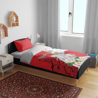 Red and white duvet bedding set on bed with two pillows and knight floral artwork