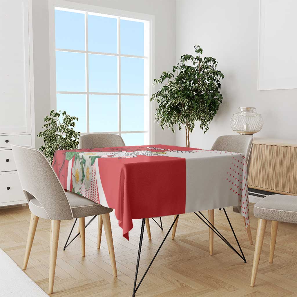 Red and white tablecloth with dotted pattern border, draped over dining table
