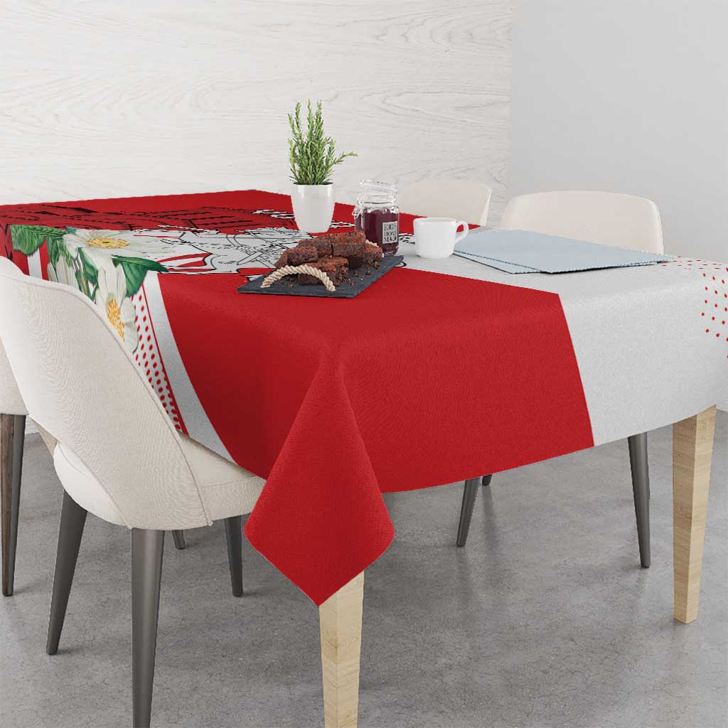 Red tablecloth with floral-and-landscape print and white dotted trim, on dining table