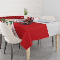 Red tablecloth with floral-and-landscape print and white dotted trim, on dining table