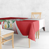 Red and white tablecloth with bold panel print and dotted edge, hanging over table