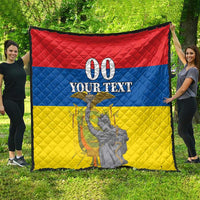 Red, blue, and yellow quilt displayed outdoors, featuring “00 YOUR TEXT” and monument graphic.