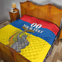 Bed quilt in red, blue, and yellow with “00 YOUR TEXT” center design and monument graphic.