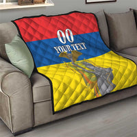 Red, blue, and yellow throw quilt on a sofa with “00 YOUR TEXT” and monument graphic.
