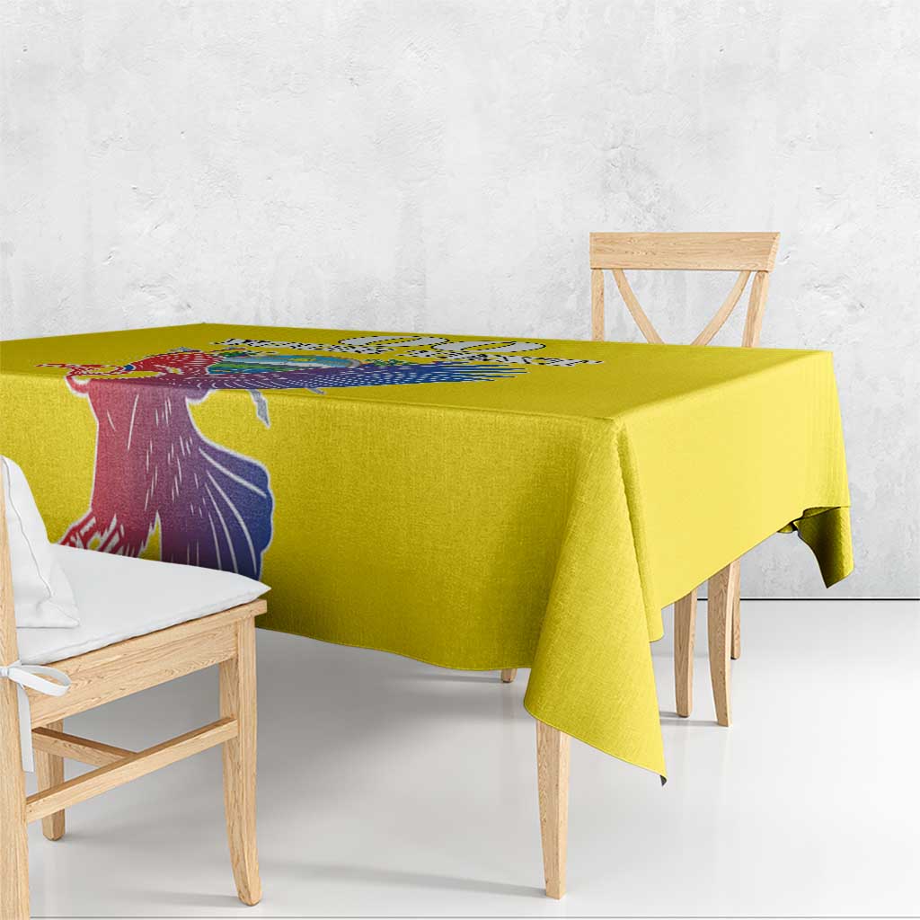 Yellow tablecloth draped over a dining table with printed condor design
