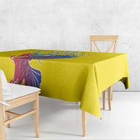 Yellow tablecloth draped over a dining table with printed condor design