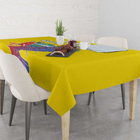Yellow tablecloth on a dining table with condor graphic and place settings