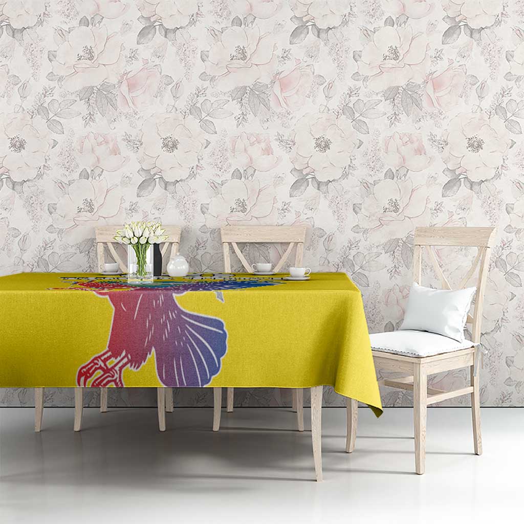 Yellow tablecloth with condor graphic printed along the table edge
