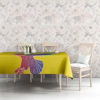 Yellow tablecloth with condor graphic printed along the table edge