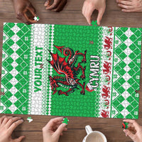 Green jigsaw puzzle in progress with red dragon, patterned border, and hands