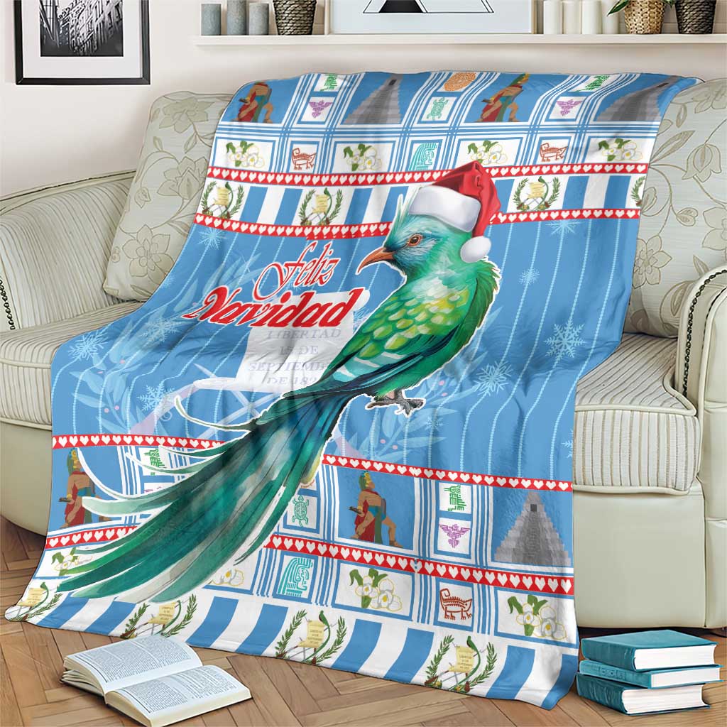 Blue Christmas blanket on sofa with green bird in Santa hat and Feliz Navidad text