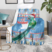 Blue Christmas blanket on floor with green bird wearing Santa hat and holiday border