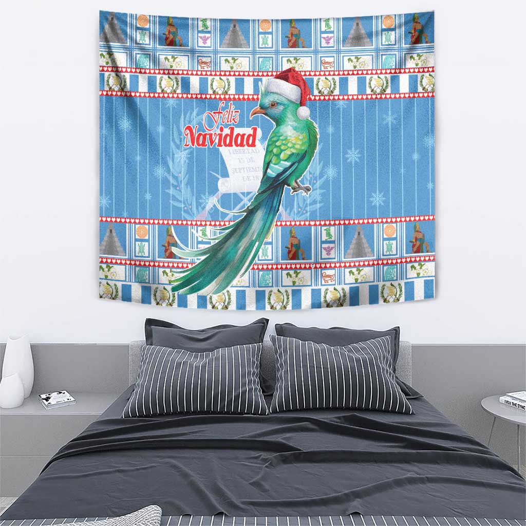 Blue Christmas tapestry featuring a green quetzal with red Santa hat, “Feliz Navidad” lettering