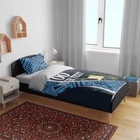 Navy and blue football bedding set on bed frame, geometric pattern and '00 YOUR TEXT'