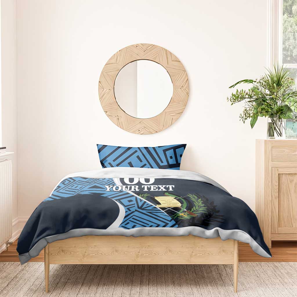 Navy duvet with blue geometric print, '00 YOUR TEXT' centered, with two matching pillowcases