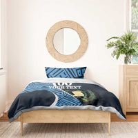 Navy duvet with blue geometric print, '00 YOUR TEXT' centered, with two matching pillowcases
