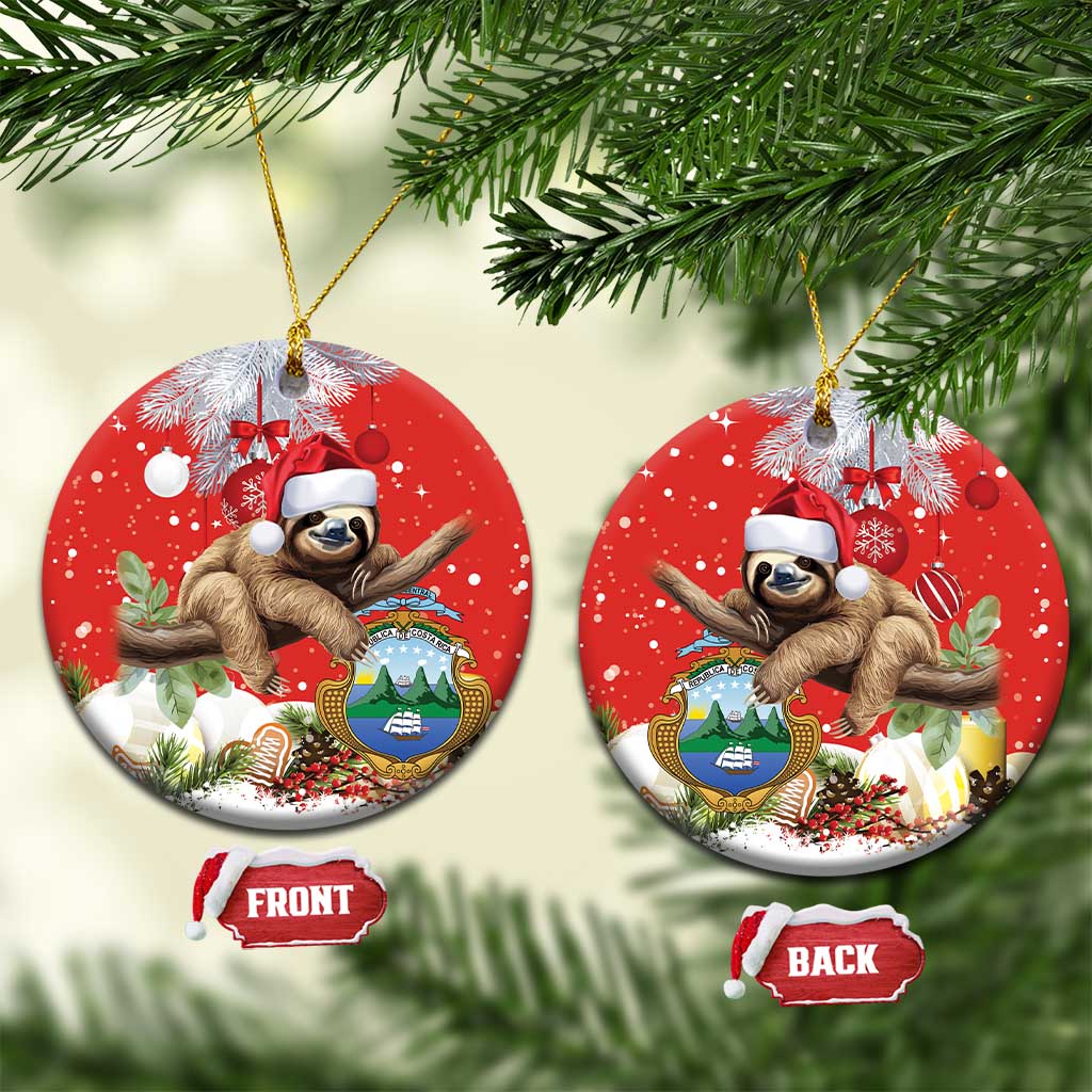Red round ceramic Christmas ornament: sloth in Santa hat, hanging string, front/back.