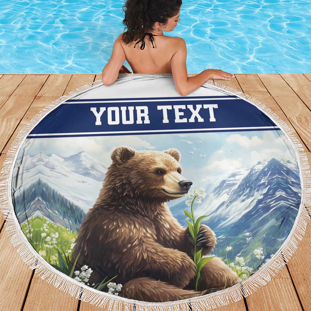 Round beach blanket with tassel fringe, brown bear holding a flower, 'YOUR TEXT' banner
