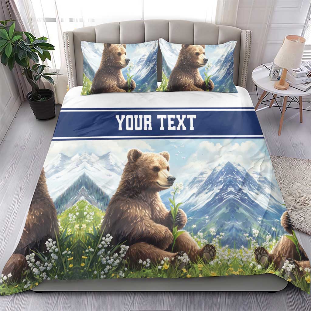 Blue duvet and pillowcase bedding set with brown bear artwork, mountain scene, and “YOUR TEXT” strip.