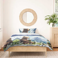 Blue bedding set featuring brown bear, mountain landscape, wildflowers, and “YOUR TEXT” center band.