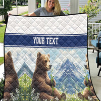 Quilt blanket with bear cubs, blue mountain landscape, and 'YOUR TEXT' banner