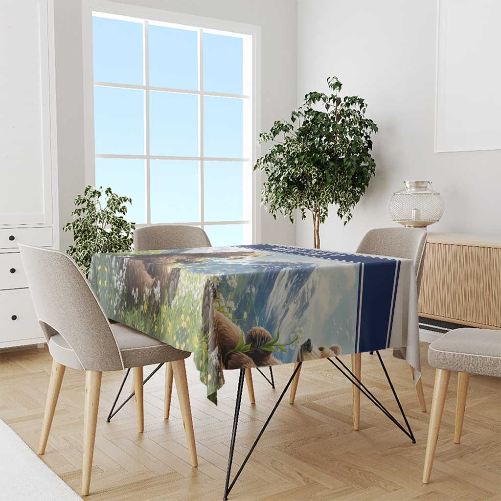Rectangular tablecloth with blue edge, bear and wildflowers scene draped on dining table