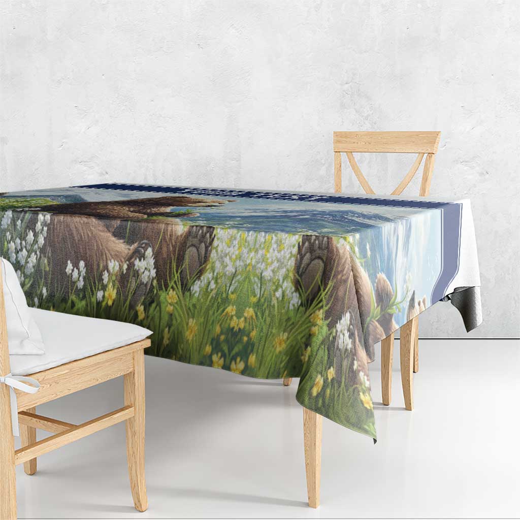 Tablecloth draped over wooden dining chairs, blue-trimmed bear and flower meadow print