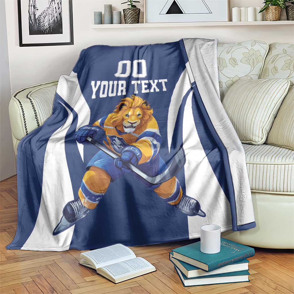 Blue and white hockey mascot blanket with custom text and “00” on a sofa