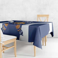 Blue and white hockey tablecloth with lion mascot graphic, hanging over bench table edge