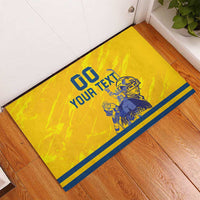 Yellow rubber hockey doormat showing '00 YOUR TEXT' and blue player graphic with striped trim