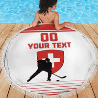 Round white beach blanket with red hockey shield graphic and fringed edge