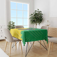 Green and yellow Brazil flag-style tablecloth covering dining table