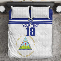 Football bedding set with white duvet, blue stripe, and two white diamond-pattern pillows