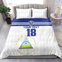 Football bedding set on bed: white duvet with blue stripe, centered crest and number 18, 2 pillows