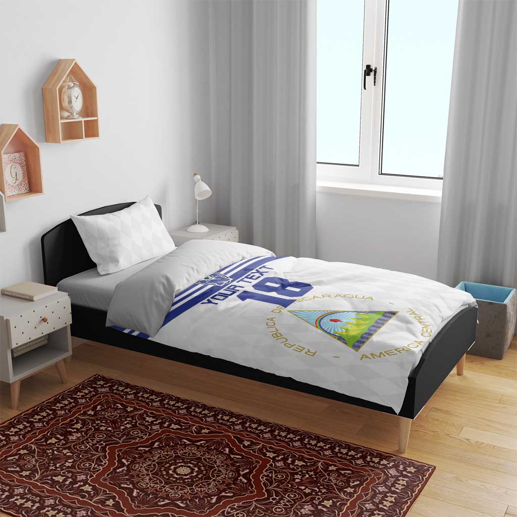 Football bedding set on bed frame: white duvet with blue stripe, number 18, and matching pillows