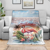 Tropical flamingo throw blanket with custom text, spread on gray sofa