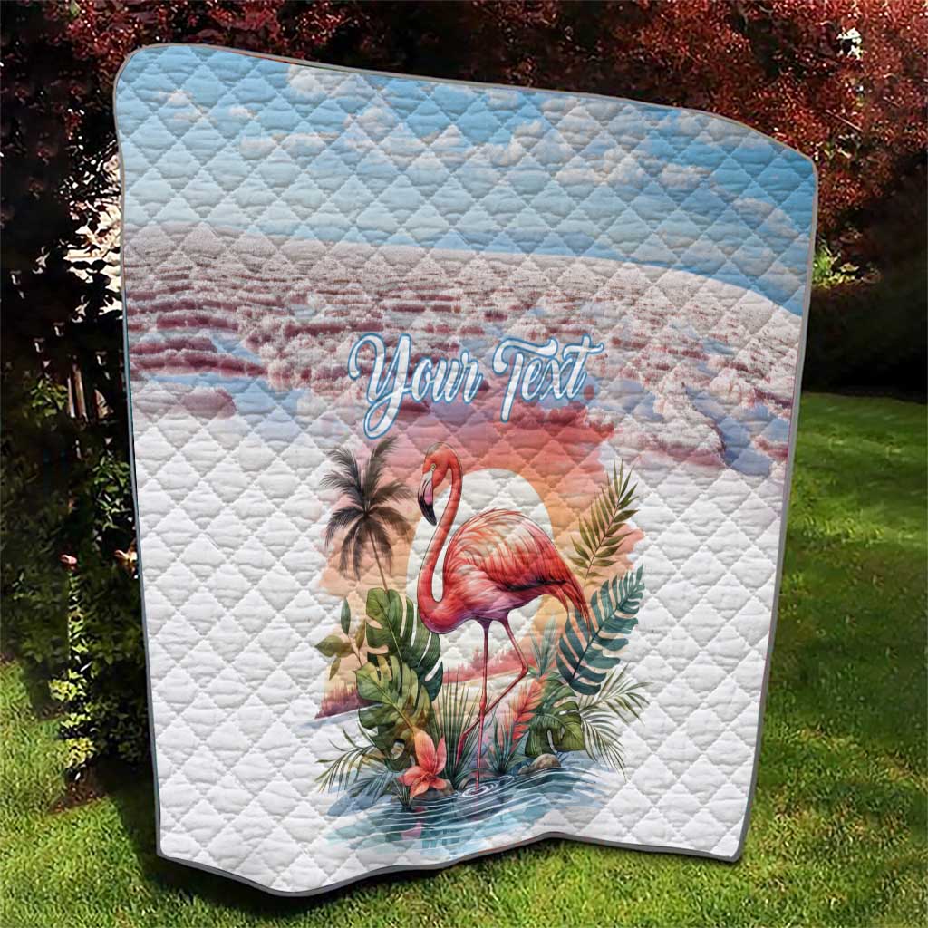 Square view of white flamingo quilt with light-blue top band, tropical plants, "Your Text" script.